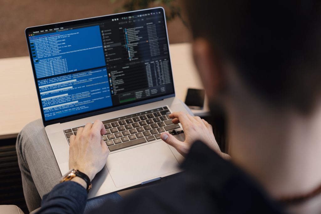 Engin8 - Man working on computer. Young it worker using laptop in the office, Internet marketing, technology, finance, business concept